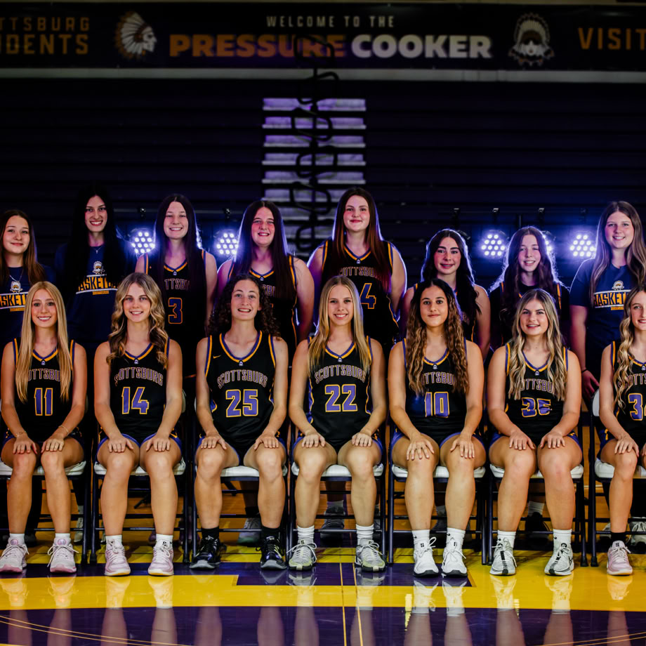 A child enjoying a birthday celebration with colorful presents and a party hat indoors.